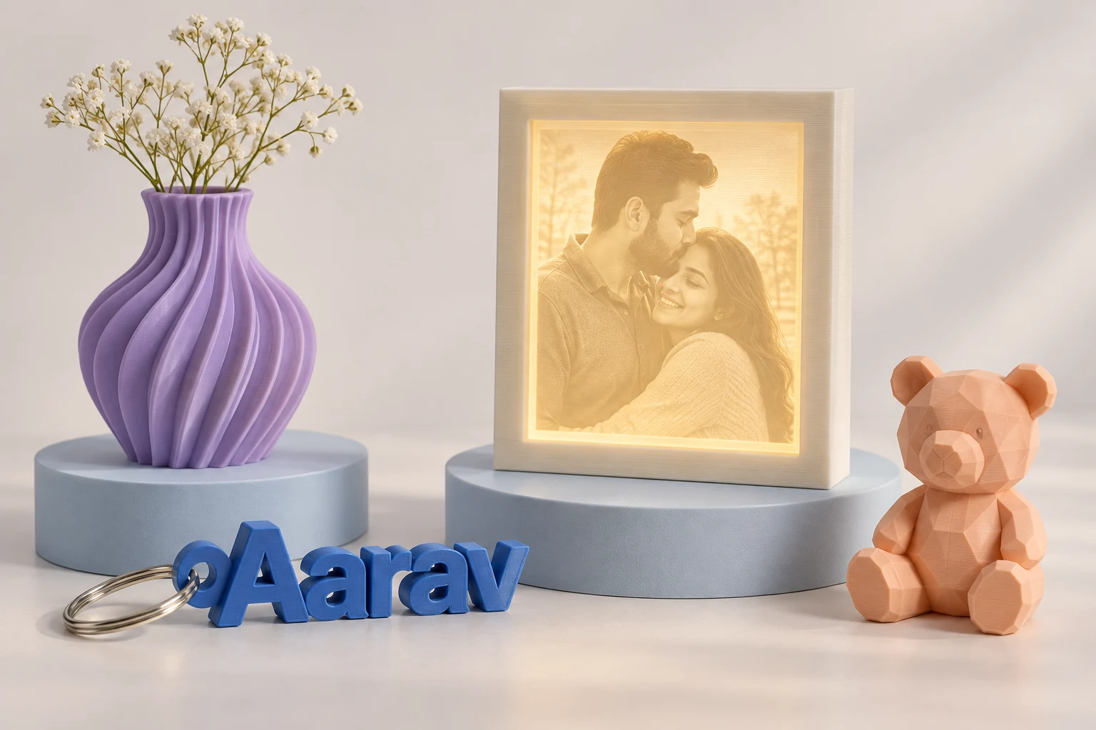 A curated collection of personalised 3D printed keychains, a glowing photo frame, sculptural vase and miniature bear